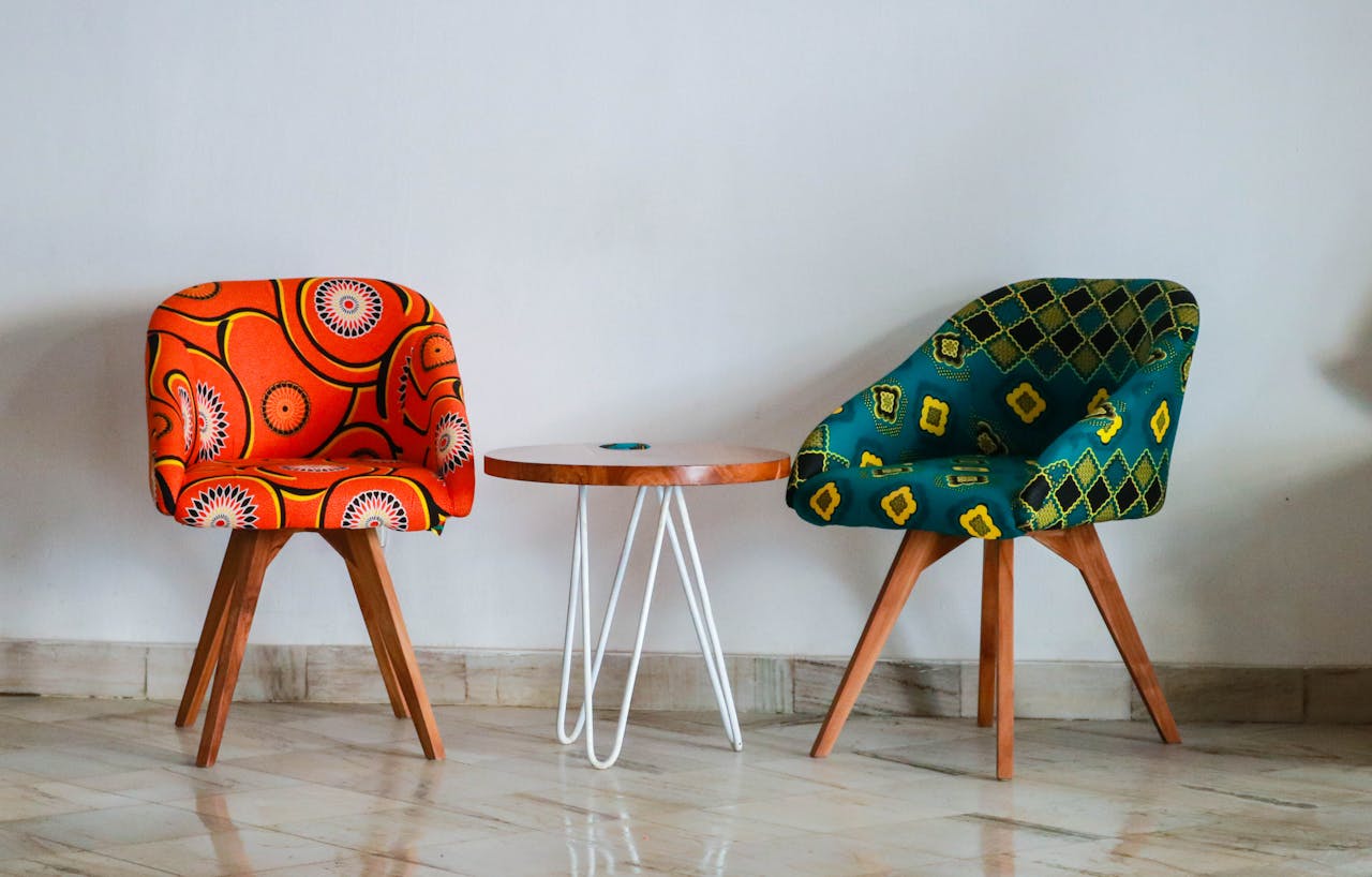 Home Brightly colored modern chairs and table in a minimalist room for vibrant decor ideas.